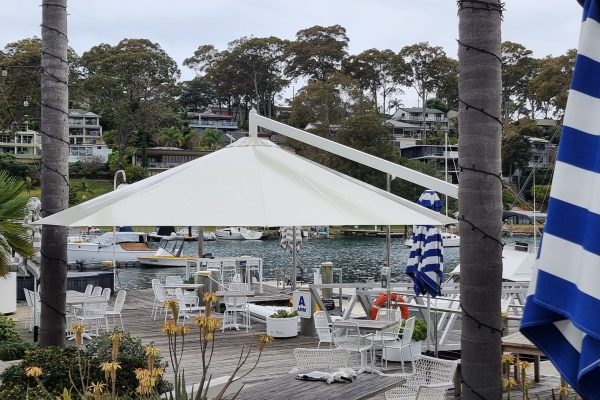 Sturdy, dependable, heavy duty shade umbrella in a coastal and exposed position at Broken Bay's Royal Motor Yacht Club.