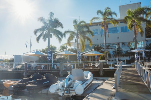 Three Revolvashade Commercial Umbrellas at Motor Yacht Club Broken Bay. Frame in textured white; canopies in Valmex FR580 Premium Pearl White